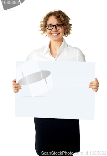 Image of Caucasian businesswoman holding a blank billboard