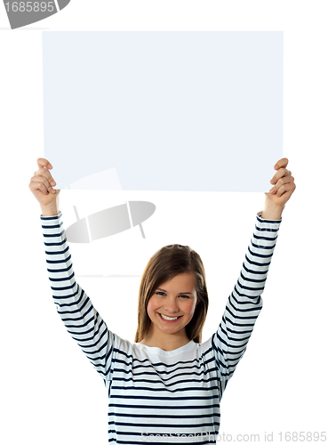 Image of Cute girl lifting blank placard high
