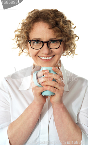 Image of Senior business woman enjoying coffee