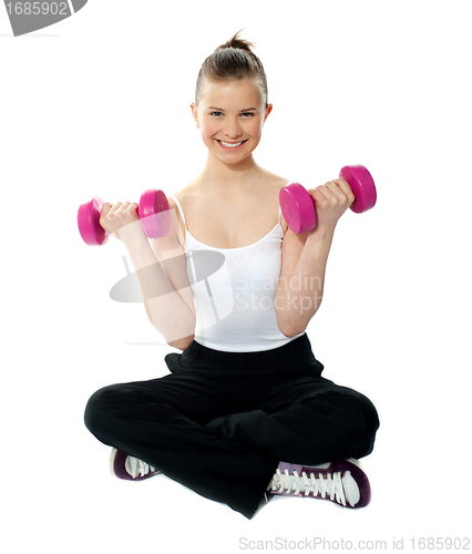 Image of Young girl lifting weights