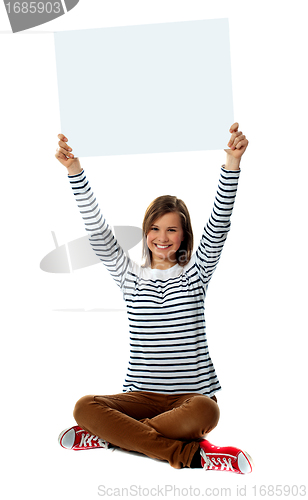 Image of Girl holding blank billboard in upward direction