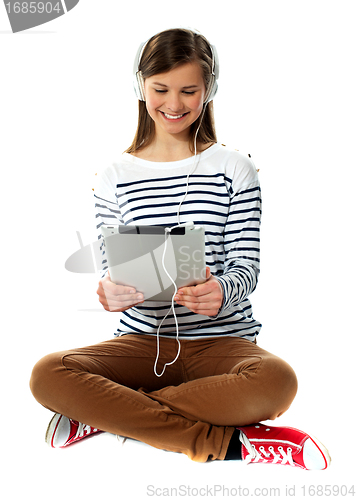 Image of Girl watching video on her tablet