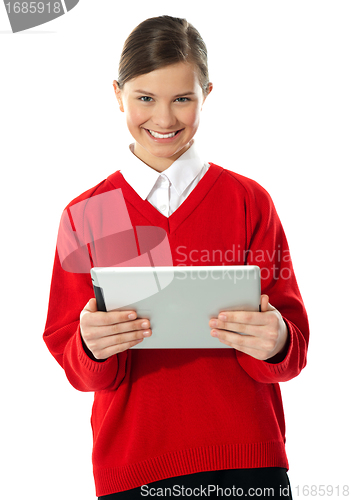 Image of School girl holding tablet computer