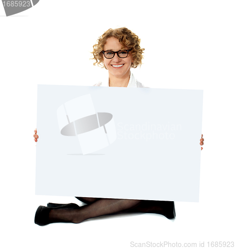 Image of Female employee holding white blank banner ad