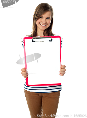 Image of Teenager showing blank paper on clipboard
