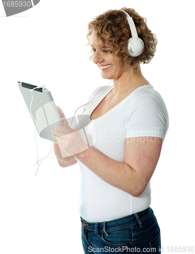 Image of Woman listening to music on her i-pad