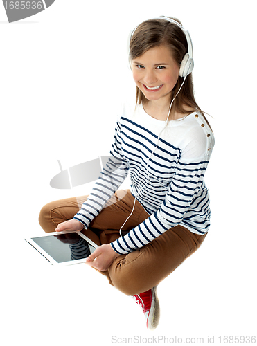 Image of Pretty girl enjoying music on headphones