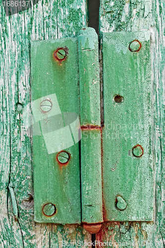 Image of Old hinges on the wooden boards