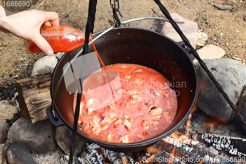 Image of tomato juice and meat in caldron