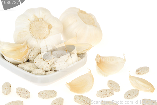 Image of Garlic and herbal supplement pills isolated, alternative medicine concept