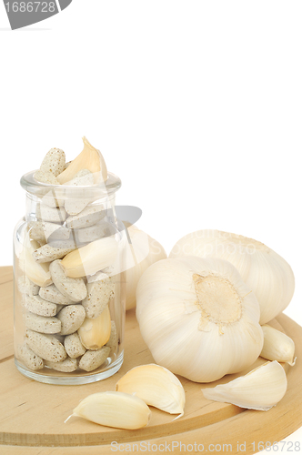 Image of Garlic and herbal supplement pills isolated, alternative medicine concept