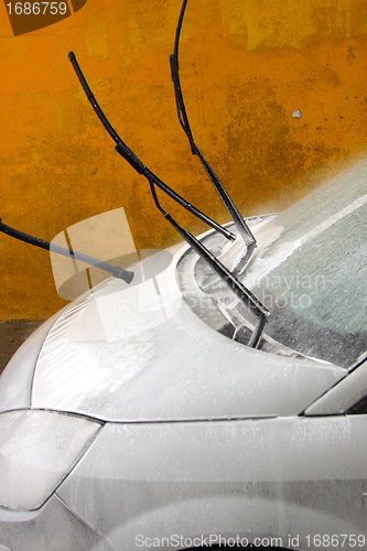 Image of a car wash with a jet of water and shampoo