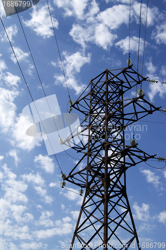 Image of Power transmission line against blue sky with clouds