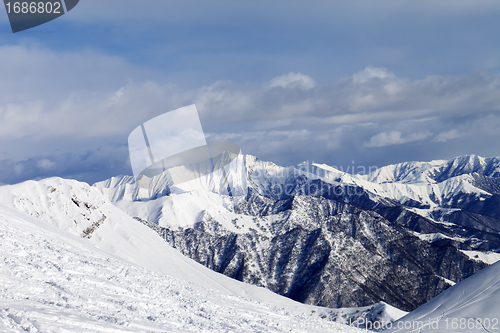 Image of Ski slope and snowy mountains