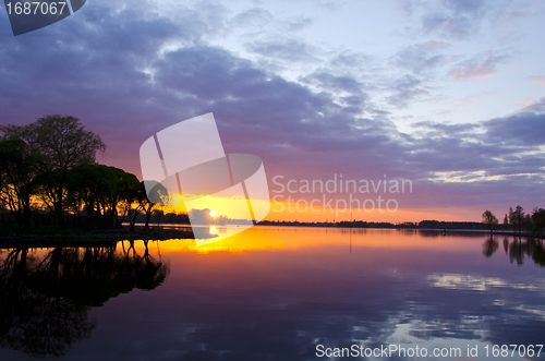 Image of summer lake sunset. Boats sky reflections water 