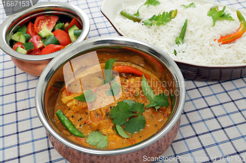 Image of Serving chicken and tomato curry