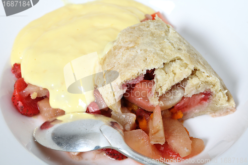 Image of Pouring custard on fruit pudding
