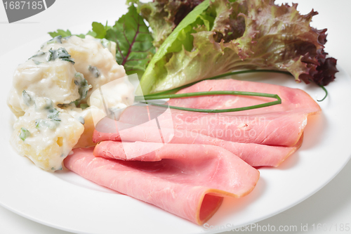 Image of Sliced smoked beef and salad side view