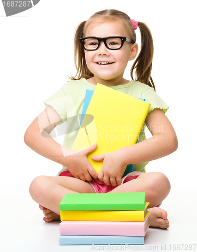 Image of Cute little girl with books