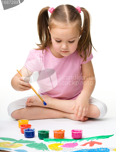 Image of Cute cheerful child play with paints