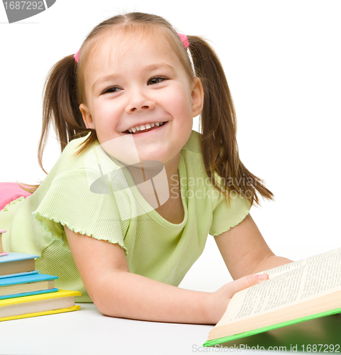 Image of Cute little girl reads a book
