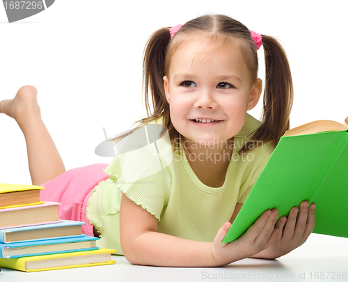 Image of Cute little girl reads a book