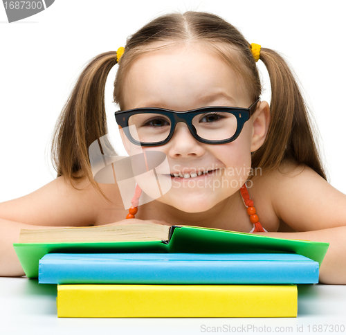 Image of Cute little girl with books