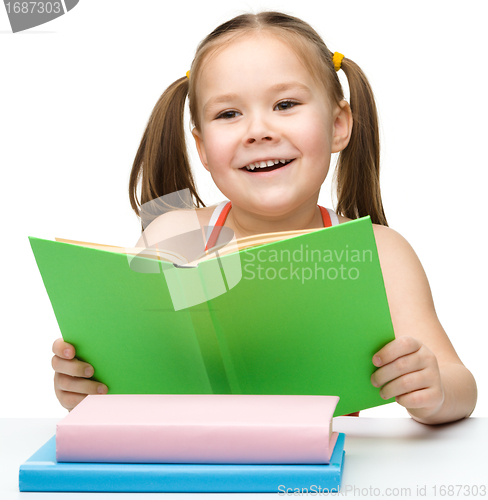 Image of Cute little girl with books