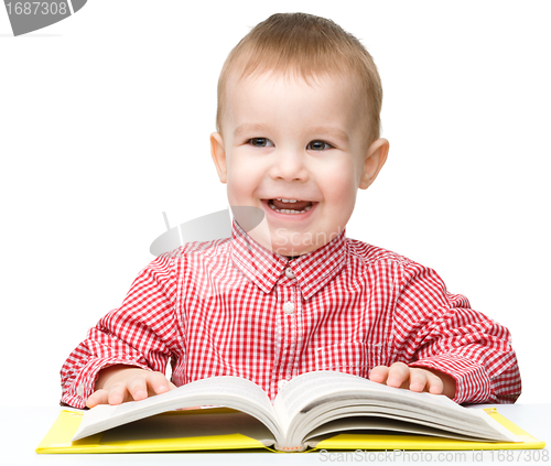 Image of Little child play with book