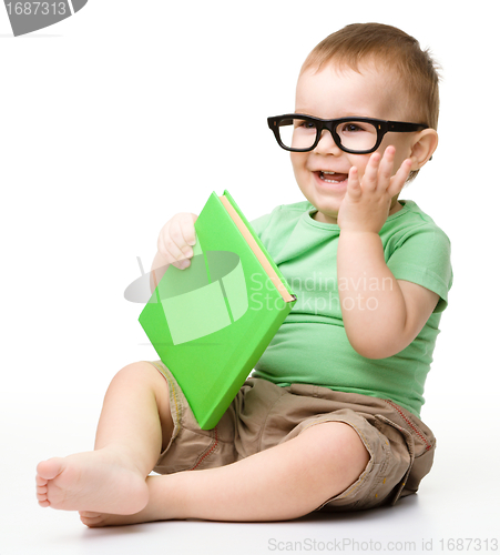 Image of Little child play with book