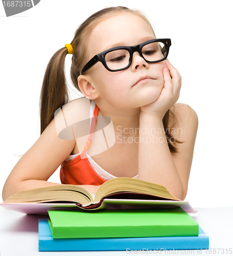 Image of Cute little girl reading book
