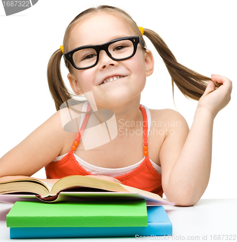 Image of Cute little girl with books