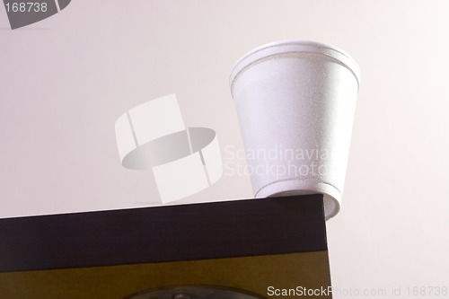 Image of Cup on table edge

