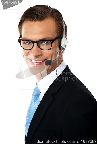 Image of Smiling telemarketing male executive, closeup shot