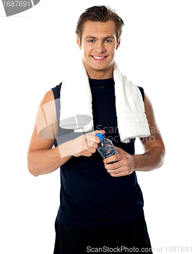 Image of Young athlete posing with water bottle