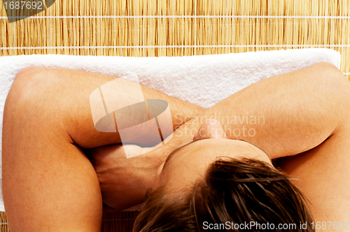 Image of Top view of young man relaxing before spa