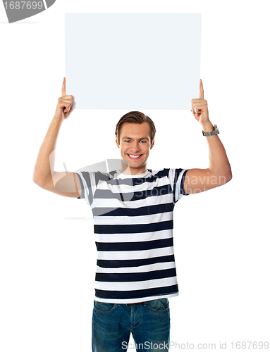 Image of Young man showing billborad over his head