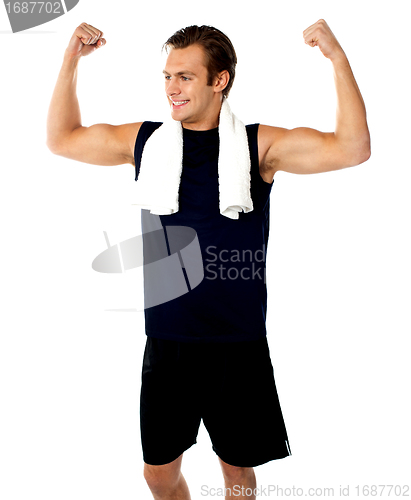 Image of Young fit guy showing biceps