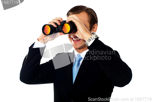Image of Business professional looking through binoculars