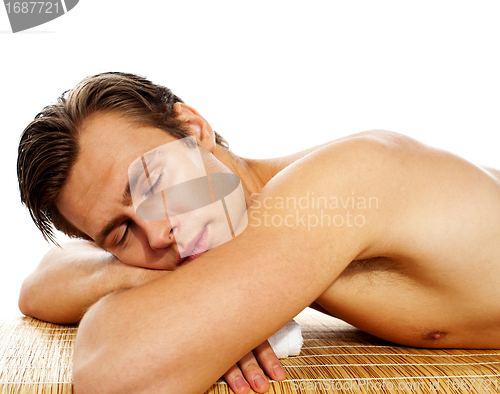 Image of Young man enjoying the treatment in spa salon