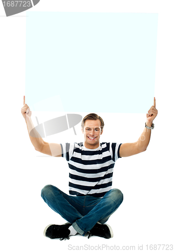 Image of Seated man showing blank signboard