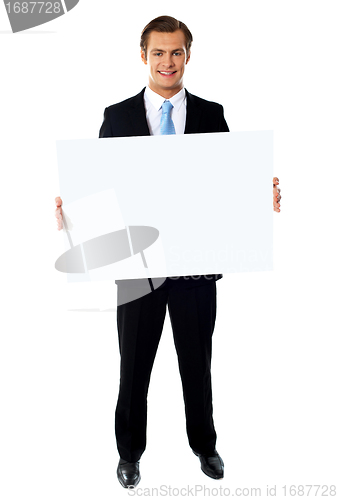 Image of Portrait of businessman showing blank signboard