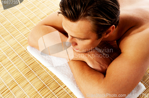 Image of Man relaxing in a spa resort on mat