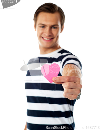 Image of Young man ofering his paper heart to you