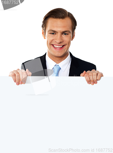 Image of Cool businessman holding a blank poster