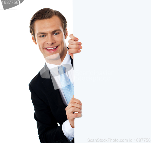 Image of Smiling business professional behind blank clipboard