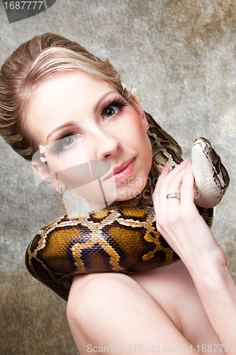 Image of Attractive nude blond woman with python on grey