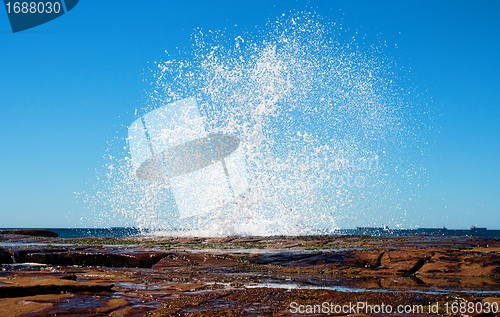 Image of big splash waves hitting rocks