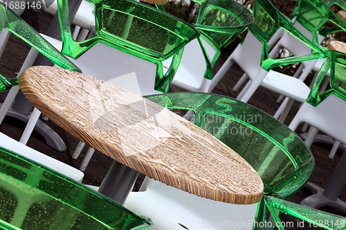 Image of wet restaurant tables and chairs