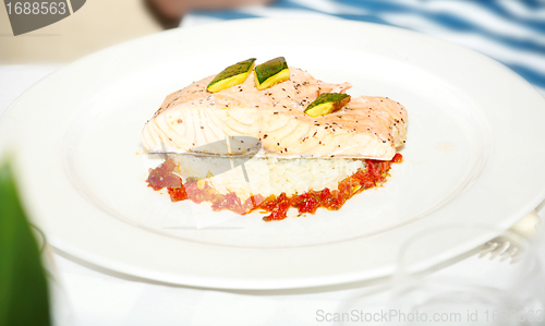 Image of Plate with baked salmon and rice with vegetables